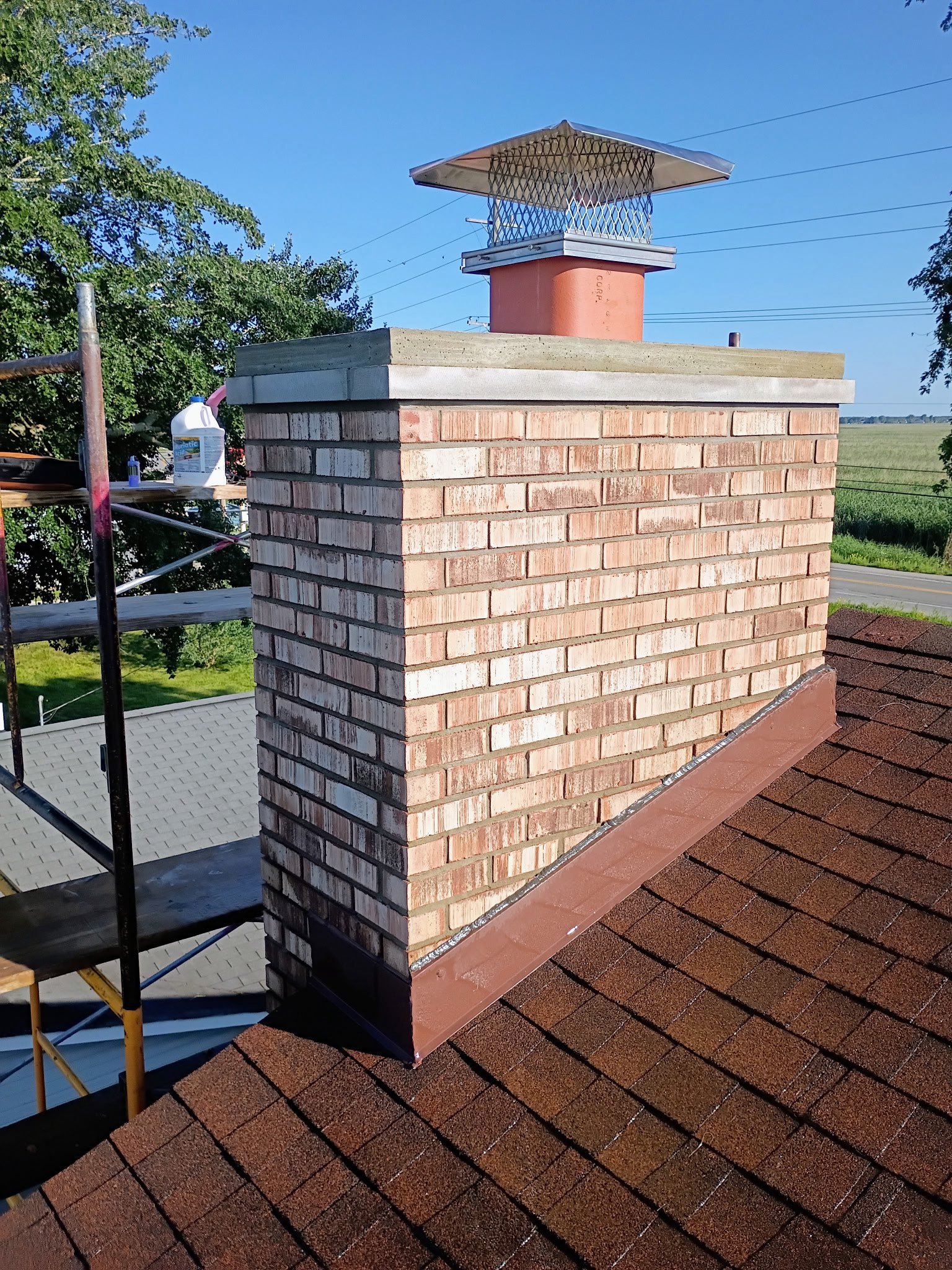 Freshly rebuilt chimney, scaffolding, blue sky